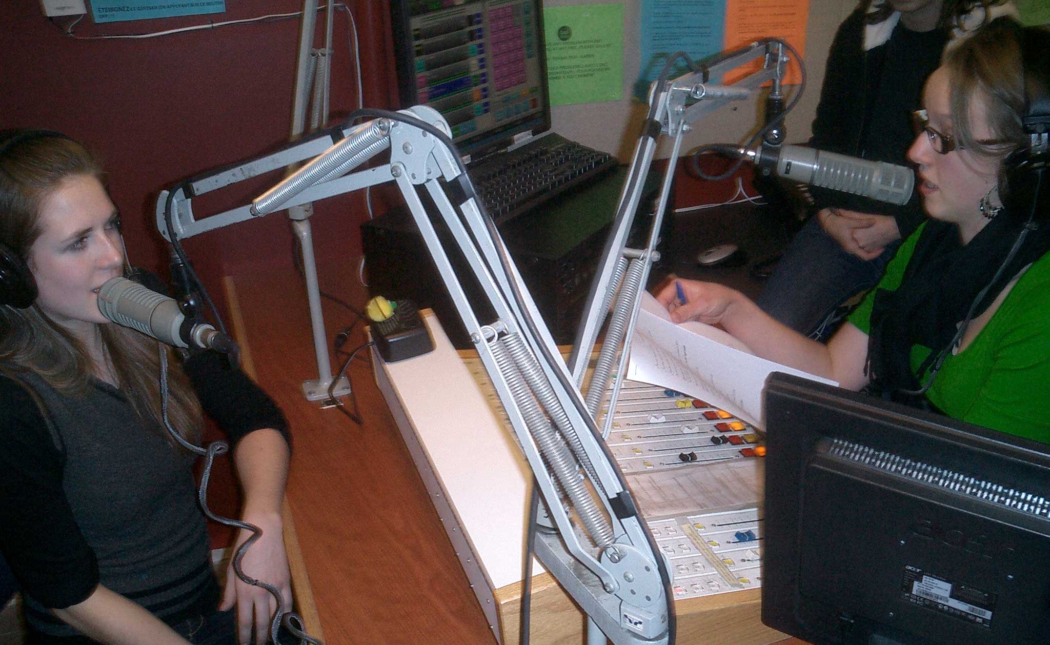 Radio host Julie Lalonde in a radio studio with a female studio guest.